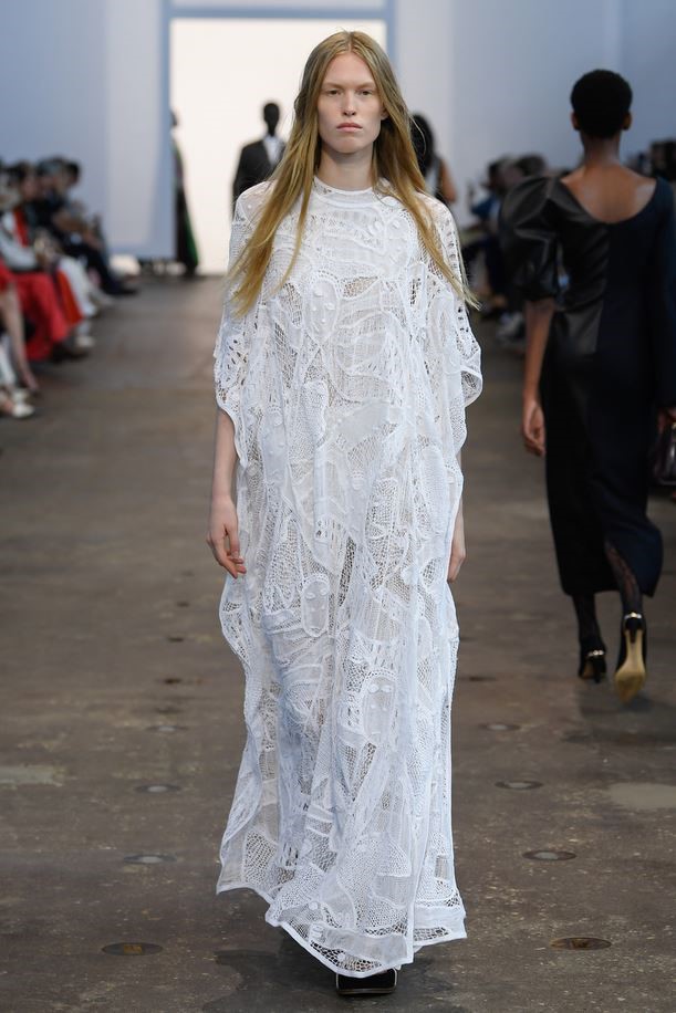 Full-length runway image of the Solrou-inspired lace dress.